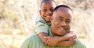 African American Man and Child Having Fun in the Park.
